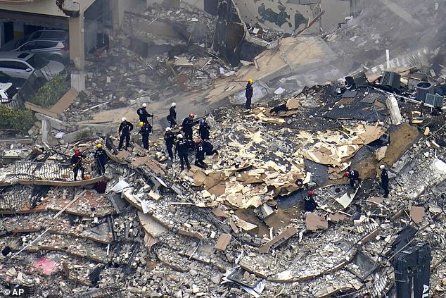 Rescue workers search in the rubble at the Champlain Towers South Condo on Friday