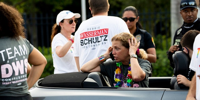 Rep. Debbie Wasserman Schultz, D-Fla., makes a call after a truck drove into a crowd of people during The Stonewall Pride Parade and Street Festival in Wilton Manors, Fla., Saturday, June 19, 2021. (Chris Day/South Florida Sun-Sentinel via AP)