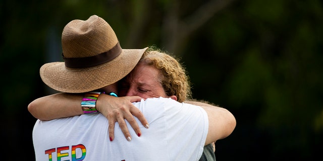 Rep. Debbie Wasserman Schultz, D-Fla., is comforted after a truck drove into a crowd of people during The Stonewall Pride Parade and Street Festival in Wilton Manors, Fla., Saturday, June 19, 2021. Wilton Manors police tweeted Saturday night that the parade was canceled due to a "tragic event." (Chris Day/South Florida Sun-Sentinel via AP)