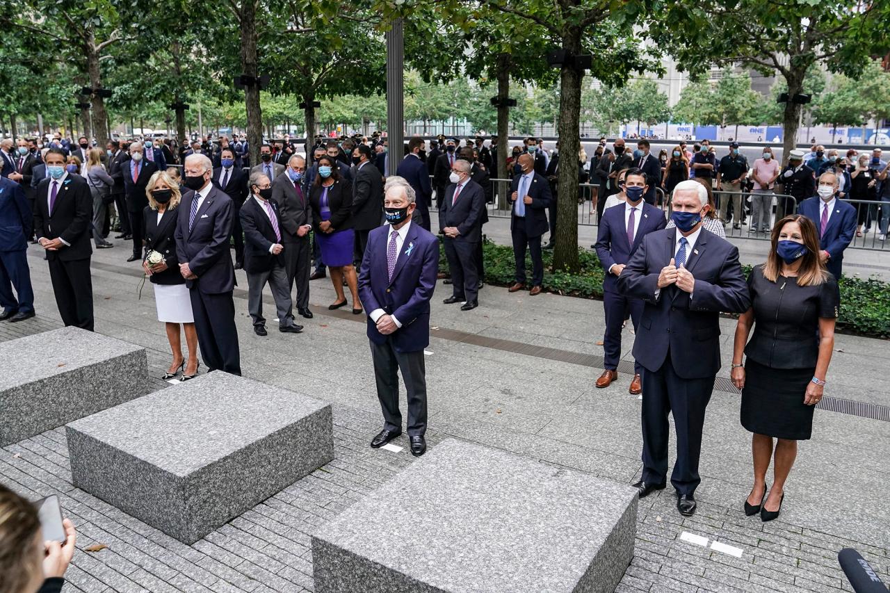 From left, New York Gov. Andrew Cuomo, Democratic presidential candidate and former Vice President Joe Biden, former New York Mayor Mike Bloomberg, and Vice President Mike Pence stand during the national anthem at the National September 11 Memorial and Museum, in 2020.
