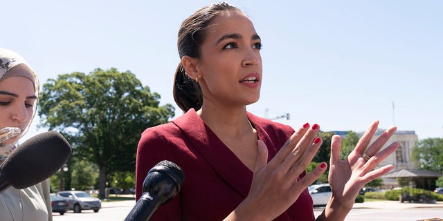 Rep. Alexandria Ocasio-Cortez, D-N.Y., speaks with reporters, Thursday, June 17, 2021, as she arrives on Capitol Hill in Washington.