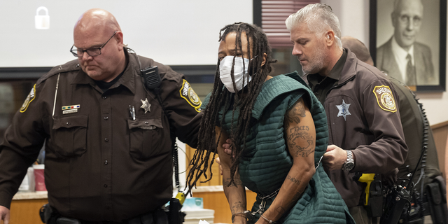Darrell Brooks, center, is escorted out of the courtroom after making his initial appearance, Tuesday in Waukesha County Court in Waukesha, Wisconsin. 