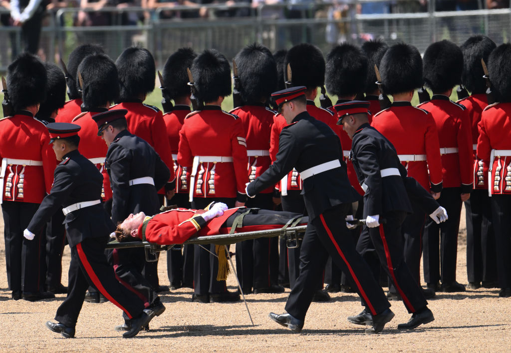 A British soldier passed out while playing the trombone in a military parade, but tried to get up and keep on tromboning.